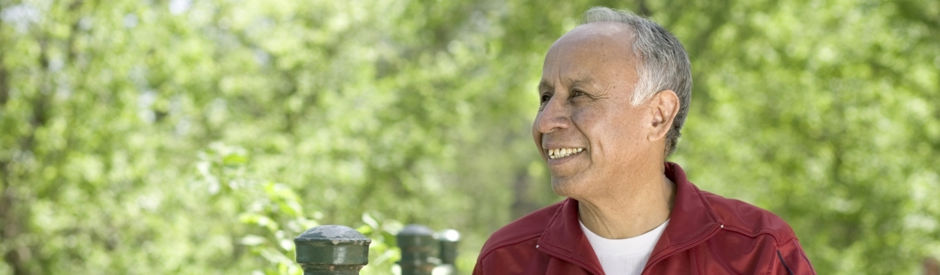 Happy Senior Man in Park with Bike