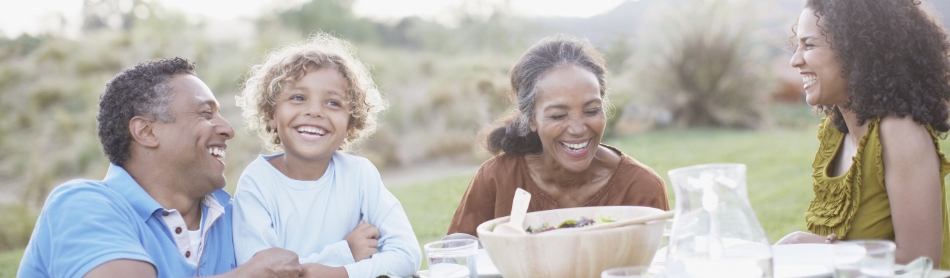 Multi-Generational Family Eating at Table Outside