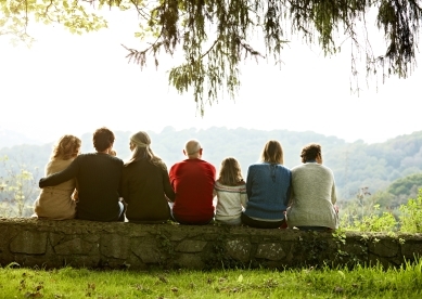 Multiple Generations of Family Sitting on Retaining Wall