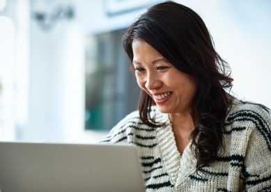 Middle Aged Woman Looking at Laptop