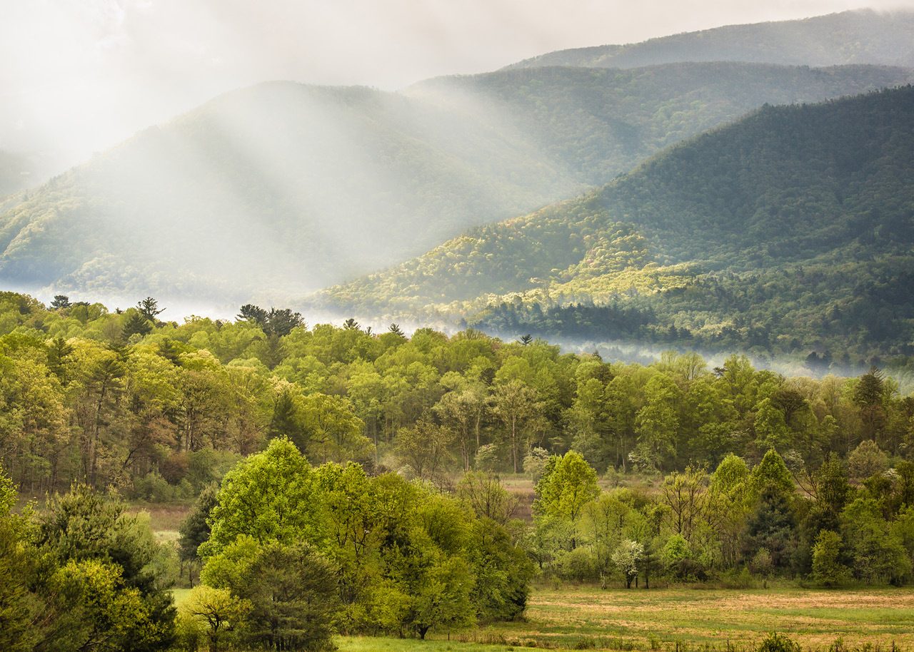 Sunlight filtering through the clouds at Cade's Cove in Tennessee